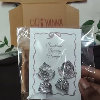 Oxidised jhumkas on a Sunshine card being packed for Priyanka